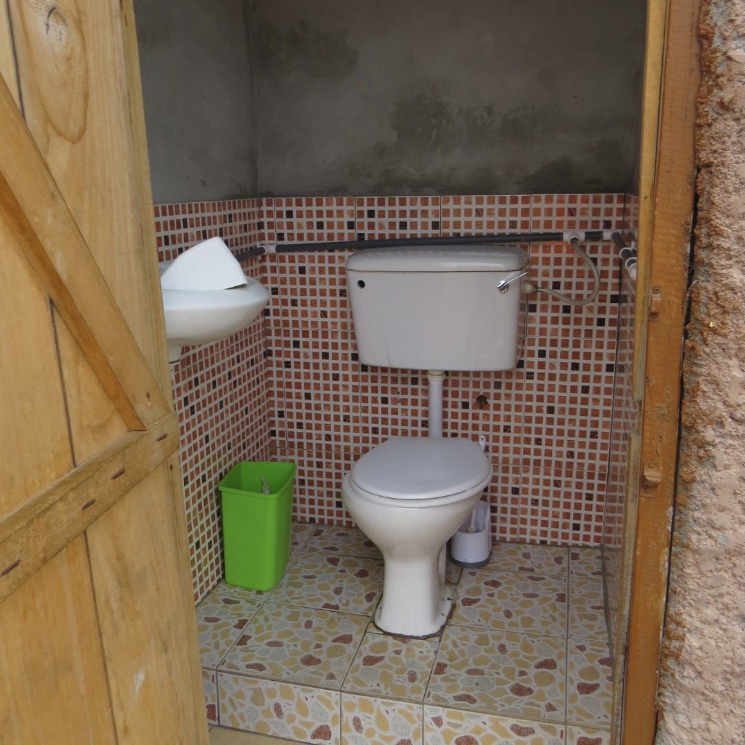 A flush toilet connected to a septic tank, which is classified as an ‘improved technology’